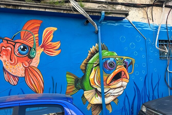 Tirana Mural Bike Tour: Street Art, Culture & Photography Stops - Stop 5: DOG and Mots mural by Kesulekuqja, a surreal pause