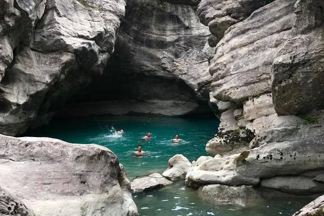 Tirana Semi-Private Hiking Tour of Pellumbas Cave & Erzeni Canyon - Wooden platform time: the calm moment inside the action